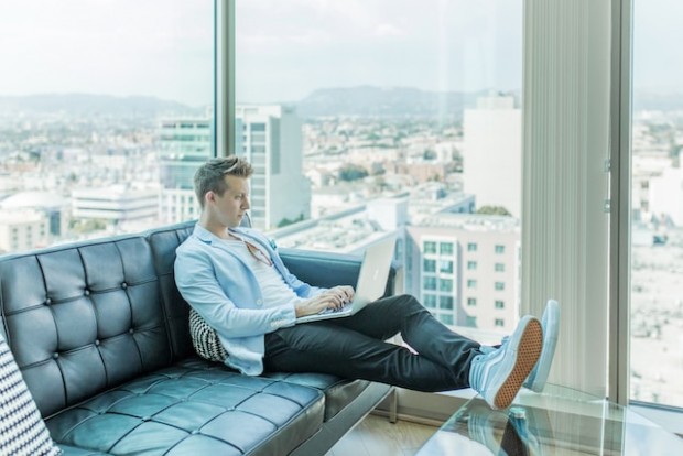 Man sitting on a sofa while working