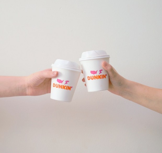 Two people with Dunkin Donut paper cup