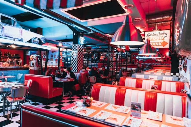 Restaurant with red and white checked tables and booths