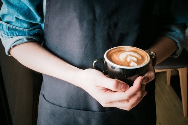 Woman holding a mug of a cappuccino