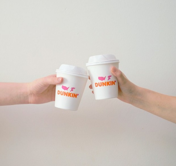 Two people with Dunkin Donut cup