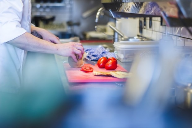 Chef sliciing tomatoes