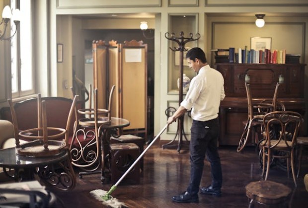 Male staff cleaning mopping the floor