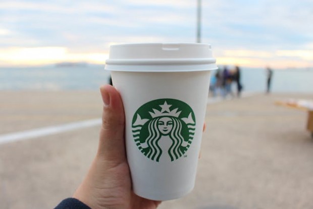 A person holding a starbucks cup