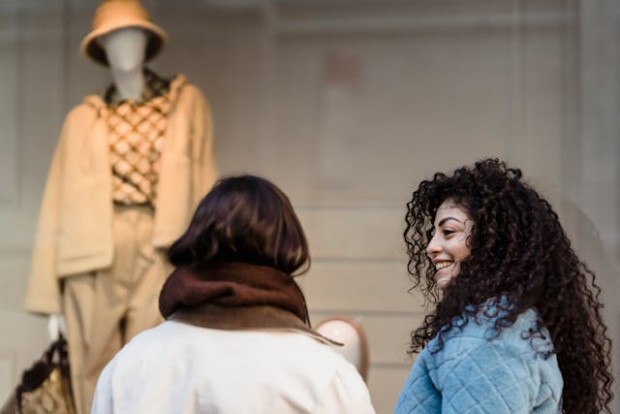 Women looking at a trendy clothes on the mannequin