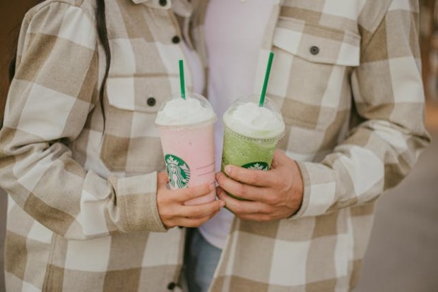 Couple holding Starbucks drinks