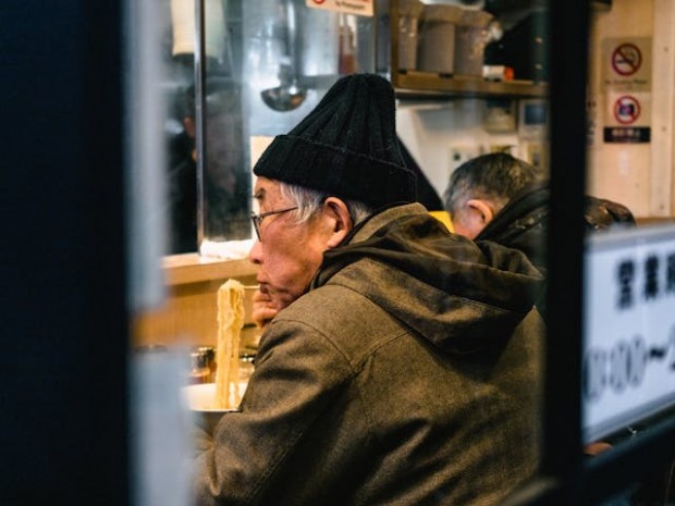 A man eating a bowl of ramen
