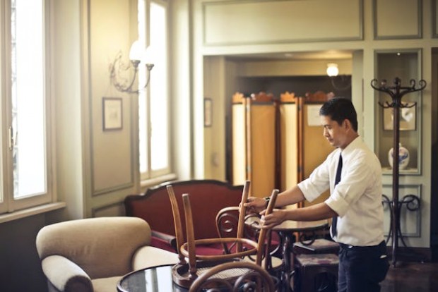 A waiter fixing the chair in a restaurant