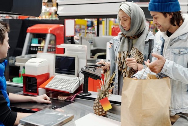 Couple paying groceries