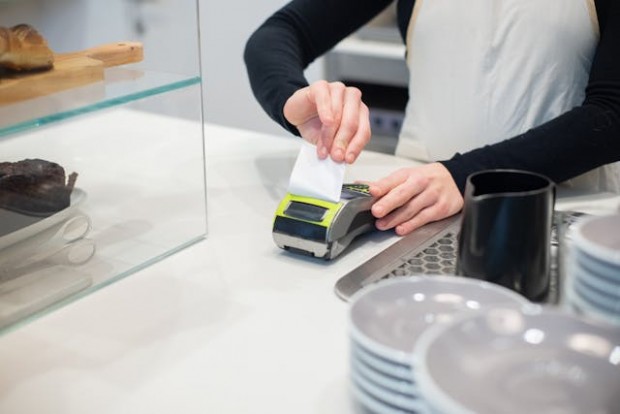 An employee using payment terminal