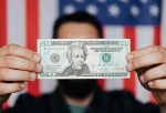 Man holding 20 U.S. Dollars