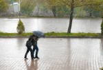 Couple walking in the street while raining
