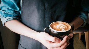 Woman holding a ucp of cappuccino