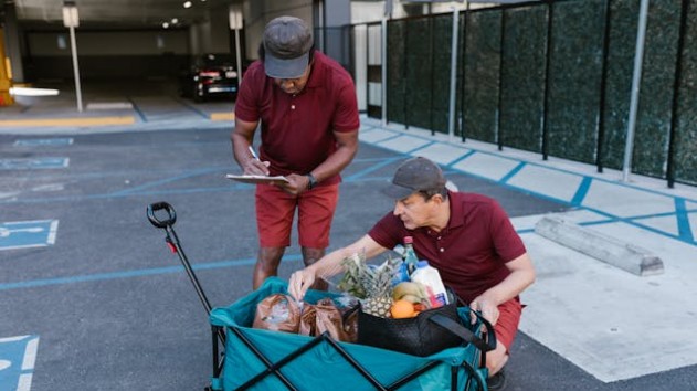 Two men checking grocery items