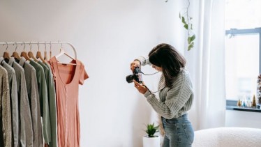 A woman taking a photo of clothes
