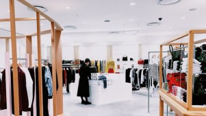 Woman standing inside a clothing area