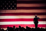 A man standing in front of a American FLag