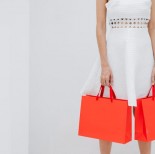 A woman carrying 2 shopping bags