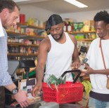 Men paying groceries