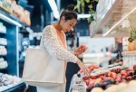 A woman buying fruits in a grocery