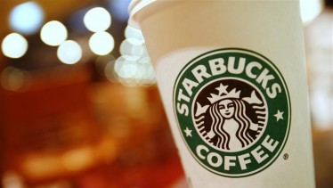 A cup of Starbucks coffee sits on a table in a cafe in central Hong Kong January 16, 2011.